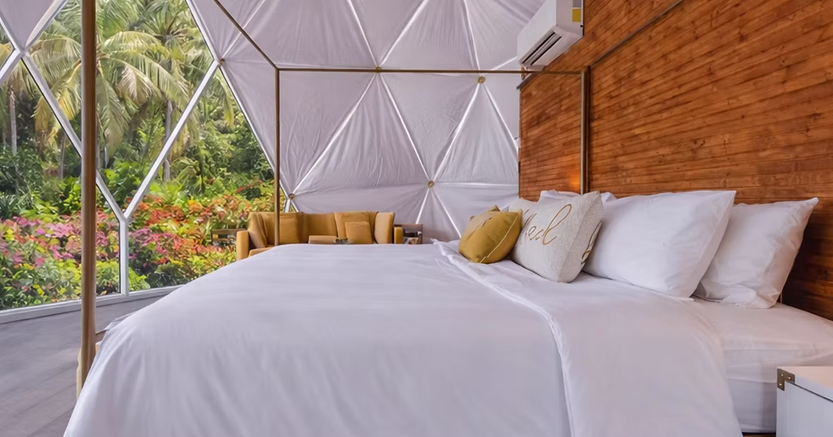 Luxury dome suite with bed and warm interior details